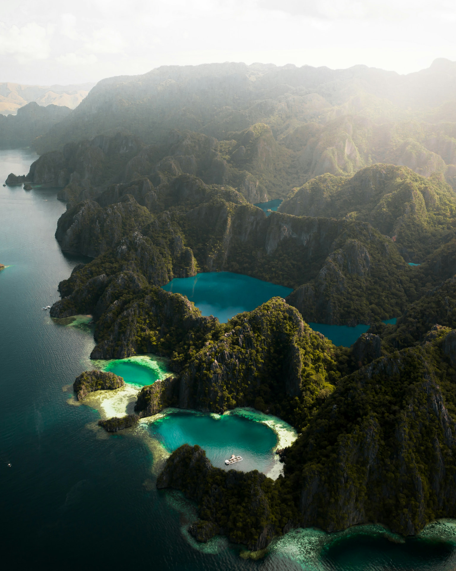 Aerial view of hidden turquoise lagoons and limestone islands in Palawan
