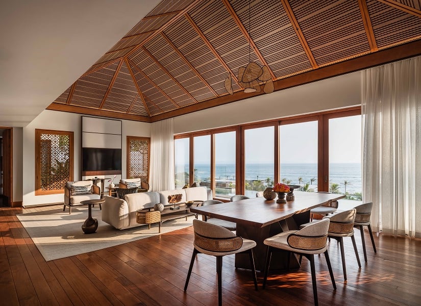 The living and dining room of an oceanfront penthouse at Regent Bali Canggu.