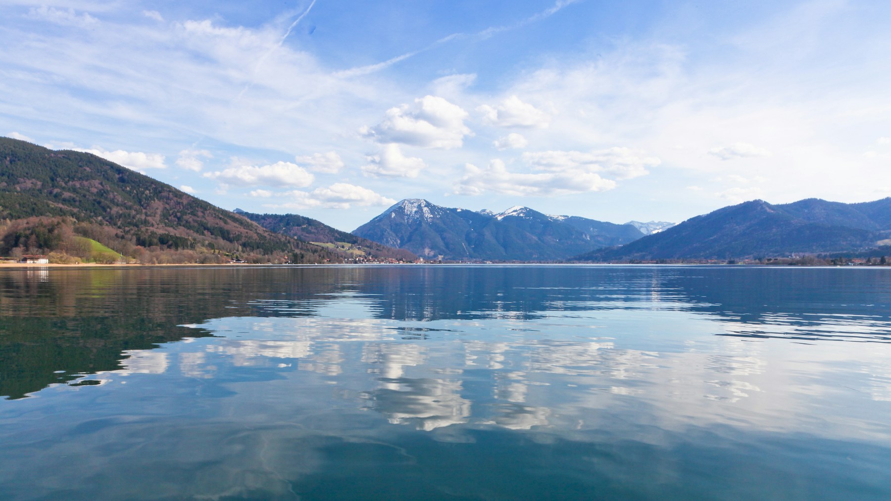 Green Bavarian foothills and a clear alpine lake.