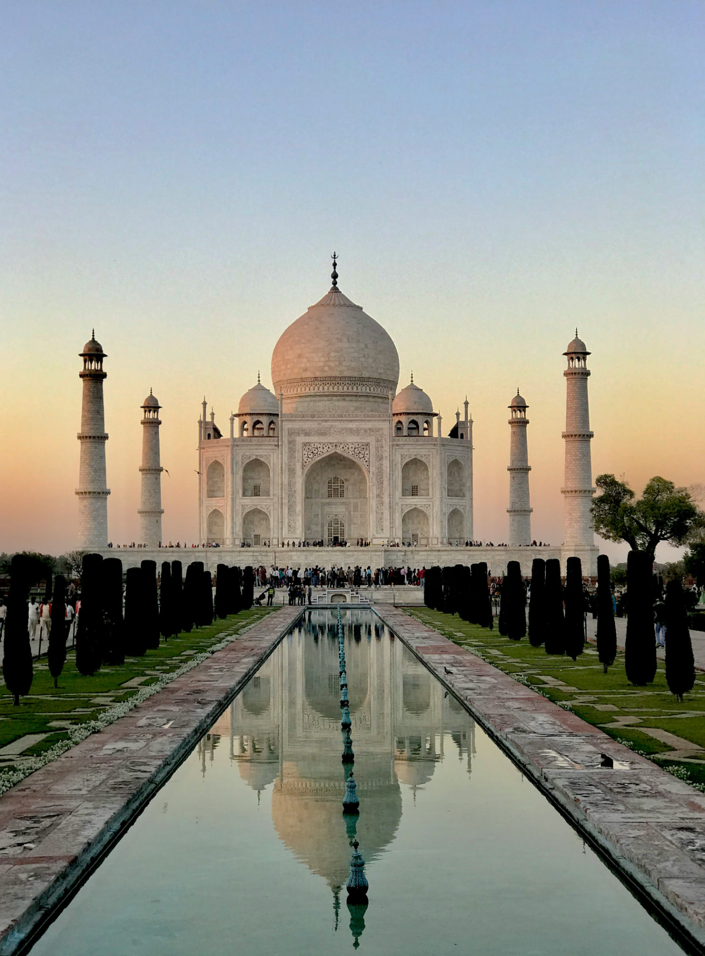 The Taj Mahal reflected in its long water garden at sunset