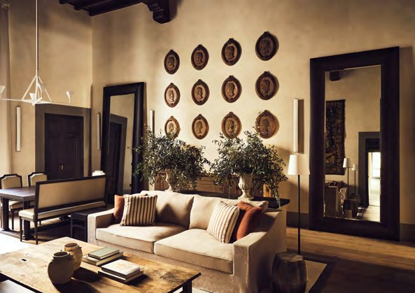 A sitting room at La Réserve Firenze with sculpted portrait roundels above the sofa.