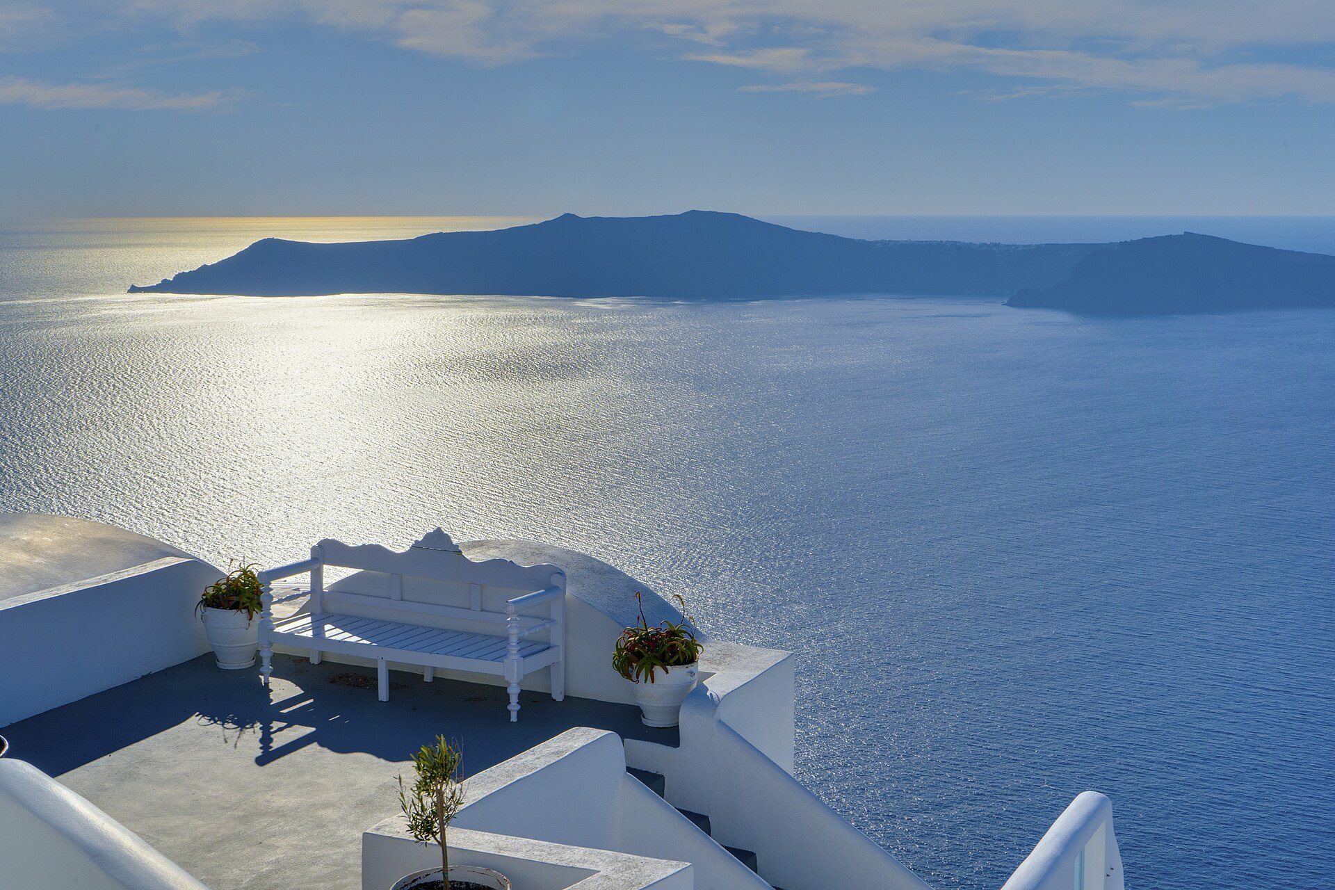 Whitewashed houses above the Santorini caldera in late afternoon light